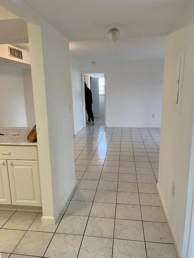 927 NE 199th St Unit 102, Miami, FL 33179 - hall featuring light marble finish flooring, baseboards, and electric panel