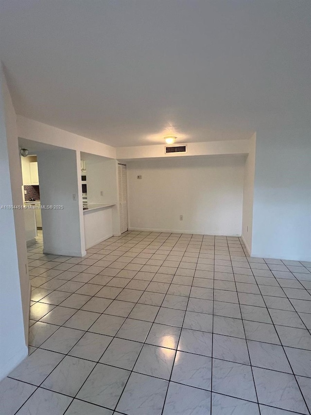 927 NE 199th St Unit 102, Miami, FL 33179 - empty room featuring light tile patterned floors
