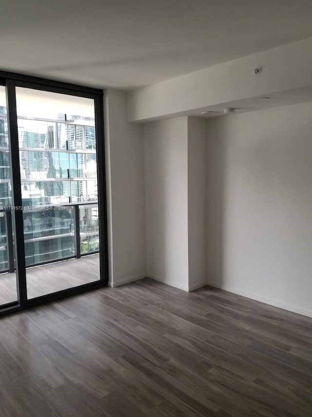 801 S Miami Ave Unit 1207, Miami, FL 33130 - unfurnished room with floor to ceiling windows and wood finished floors