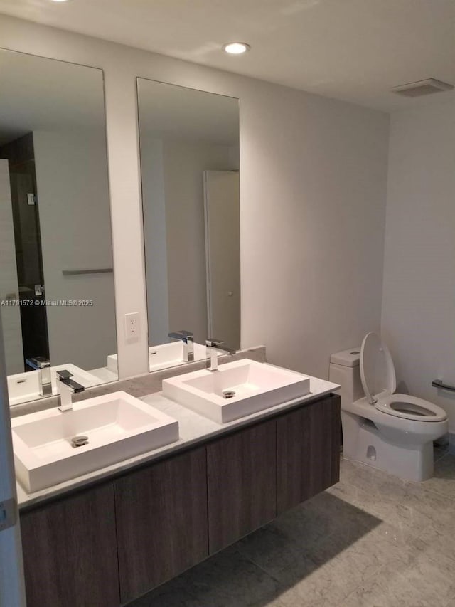 801 S Miami Ave Unit 1207, Miami, FL 33130 - bathroom featuring toilet, double vanity, and recessed lighting