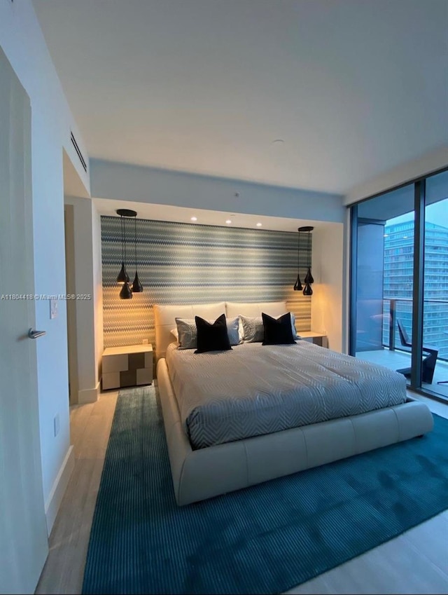 1000 Brickell Plz Unit 3308, Miami, FL 33131 - bedroom with access to exterior, floor to ceiling windows, baseboards, wood finished floors, and wallpapered walls