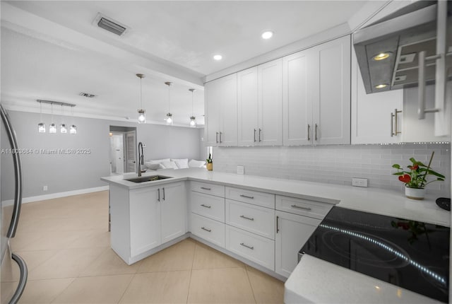 4301 SW 85th Ave, Miami, FL 33155 - kitchen featuring a sink, wall chimney range hood, a peninsula, light countertops, and tasteful backsplash