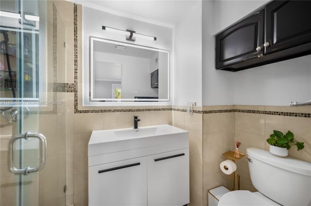 4301 SW 85th Ave, Miami, FL 33155 - full bathroom with tile walls, a stall shower, toilet, vanity, and a wainscoted wall