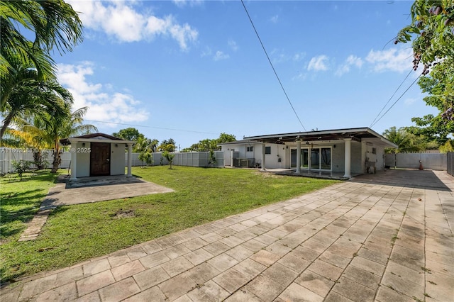 4301 SW 85th Ave, Miami, FL 33155 - view of yard featuring a patio area, ceiling fan, a storage unit, and driveway