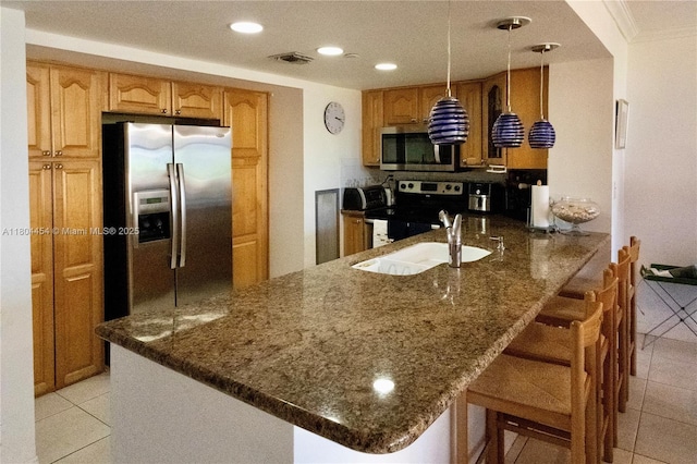 2555 Collins Ave Unit 308, Miami Beach, FL 33140 - kitchen featuring appliances with stainless steel finishes, light tile patterned flooring, dark stone counters, and recessed lighting