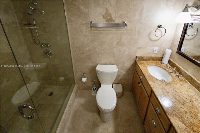 2555 Collins Ave Unit 308, Miami Beach, FL 33140 - bathroom featuring a tile shower, toilet, vanity, and tile patterned floors