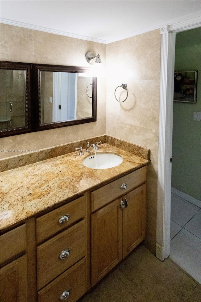 2555 Collins Ave Unit 308, Miami Beach, FL 33140 - bathroom with tile patterned floors, vanity, and ornamental molding