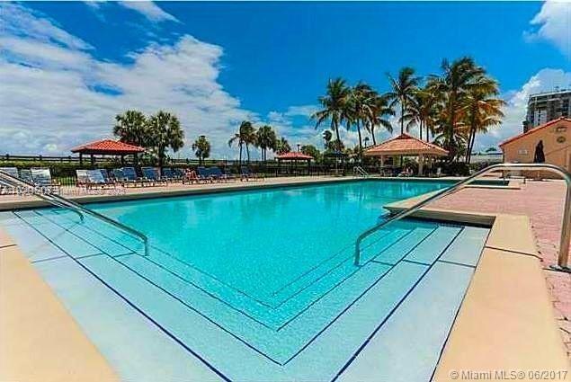 2555 Collins Ave Unit 308, Miami Beach, FL 33140 - community pool with a gazebo and fence