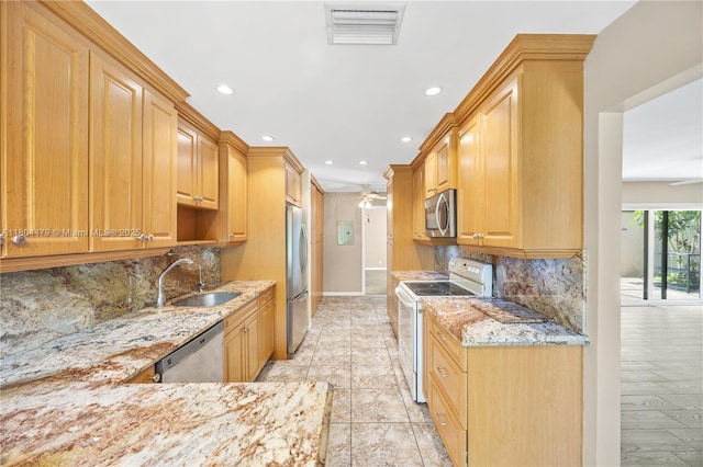 2717 N Carambola Cir N Unit 17101, Coconut Creek, FL 33066 - kitchen featuring stainless steel appliances, a sink, light stone counters, a ceiling fan, and recessed lighting