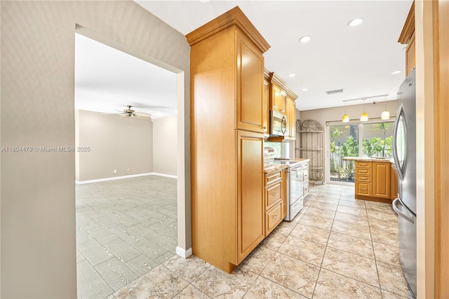 2717 N Carambola Cir N Unit 17101, Coconut Creek, FL 33066 - kitchen with appliances with stainless steel finishes, a ceiling fan, baseboards, recessed lighting, and hanging light fixtures