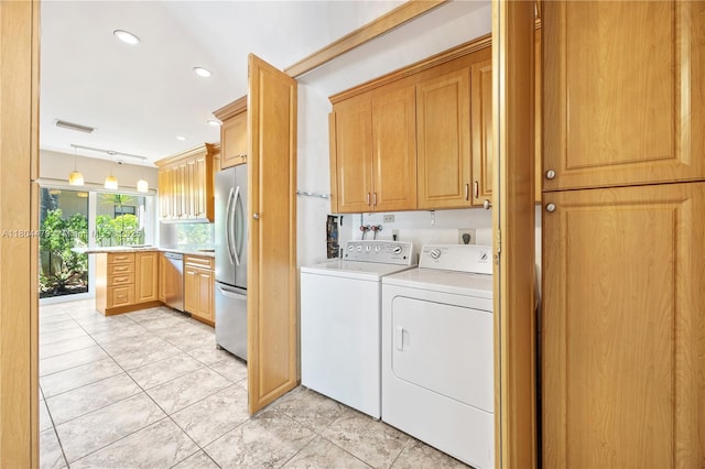 2717 N Carambola Cir N Unit 17101, Coconut Creek, FL 33066 - clothes washing area with washer and dryer, cabinet space, recessed lighting, and light tile patterned flooring