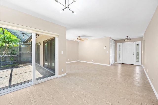 2717 N Carambola Cir N Unit 17101, Coconut Creek, FL 33066 - empty room featuring light wood-style floors, baseboards, and ceiling fan
