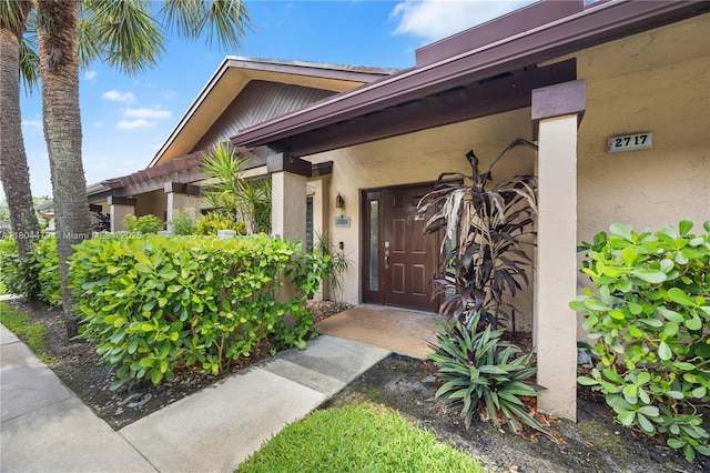 2717 N Carambola Cir N Unit 17101, Coconut Creek, FL 33066 - view of exterior entry featuring stucco siding