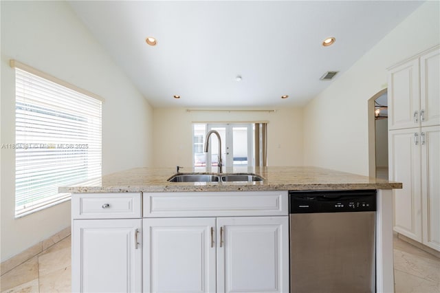 kitchen featuring dishwasher, a sink, arched walkways, light stone counters, and recessed lighting