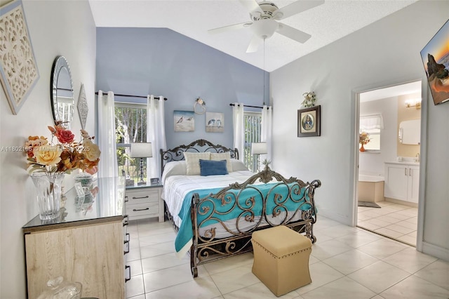 bedroom with vaulted ceiling, light tile patterned floors, ensuite bath, and a ceiling fan
