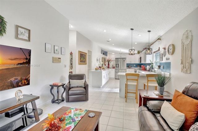 living room featuring light tile patterned floors, recessed lighting, and a textured ceiling