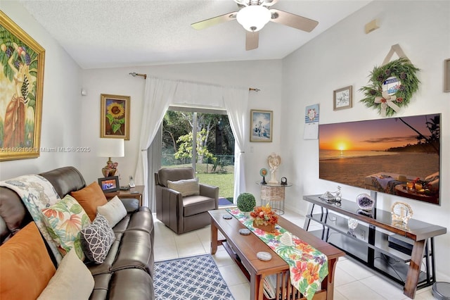 living room featuring lofted ceiling, light tile patterned flooring, a ceiling fan, and a textured ceiling