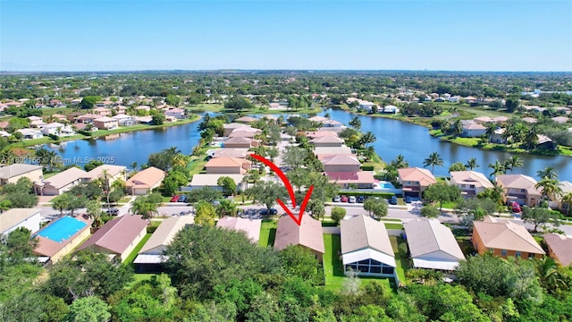 aerial view of residential area featuring a large body of water