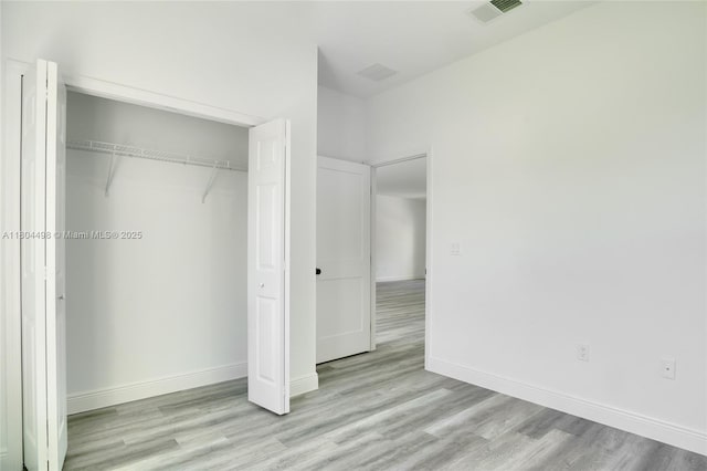 5998 SW 128th Street Rd, Ocala, FL 34473 - unfurnished bedroom with wood finished floors, a closet, and baseboards