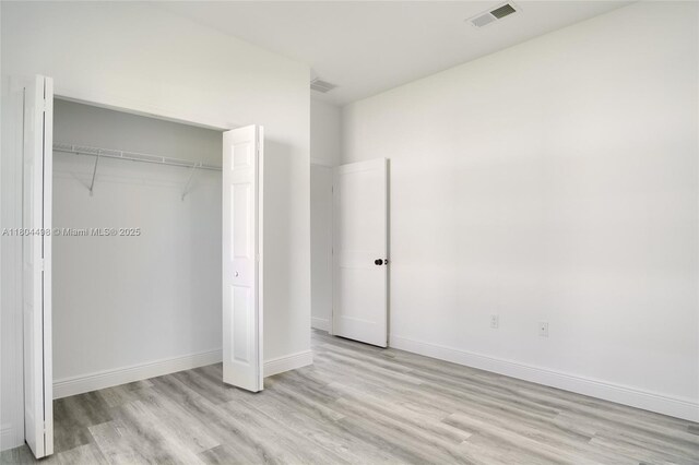 5998 SW 128th Street Rd, Ocala, FL 34473 - unfurnished bedroom featuring light wood-type flooring, a closet, and baseboards