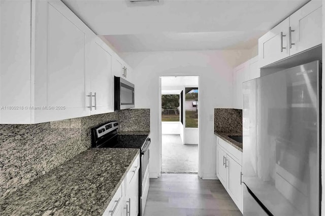 15351 SW 296th St, Homestead, FL 33033 - kitchen featuring stainless steel appliances, tasteful backsplash, dark stone countertops, and white cabinetry