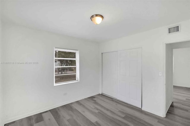 15351 SW 296th St, Homestead, FL 33033 - unfurnished bedroom with wood finished floors, a closet, and baseboards