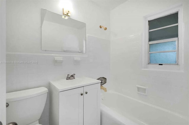 15351 SW 296th St, Homestead, FL 33033 - bathroom featuring vanity, toilet, tile walls, and washtub / shower combination
