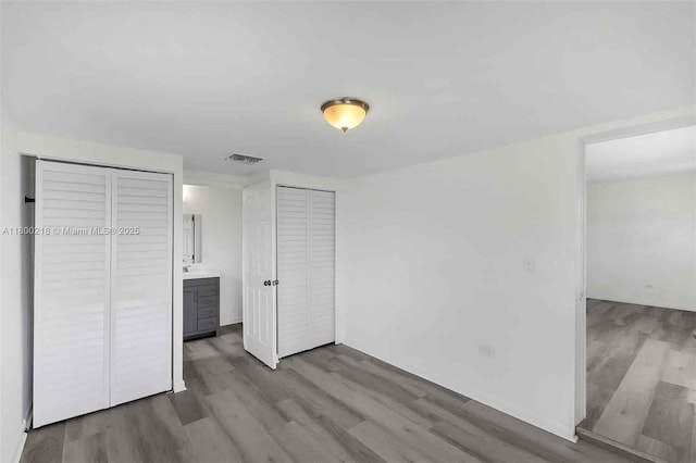 15351 SW 296th St, Homestead, FL 33033 - unfurnished bedroom featuring wood finished floors and multiple closets
