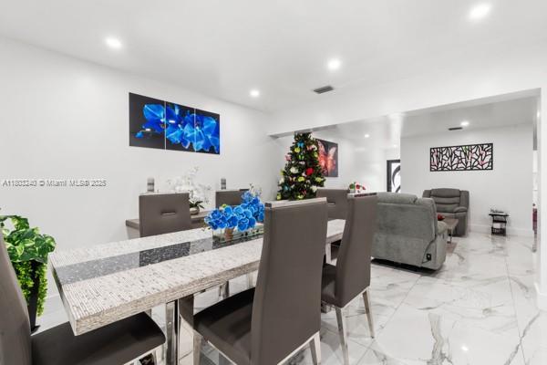 dining space with recessed lighting and light marble finish flooring