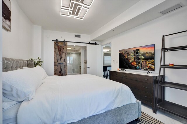18201 Collins Ave Unit 808, Sunny Isles Beach, FL 33160 - bedroom featuring a barn door and connected bathroom
