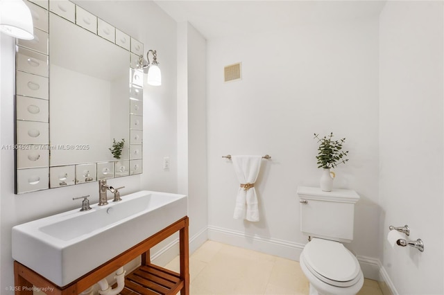 5860 La Gorce Dr, Miami Beach, FL 33140 - half bath with baseboards, toilet, and vanity
