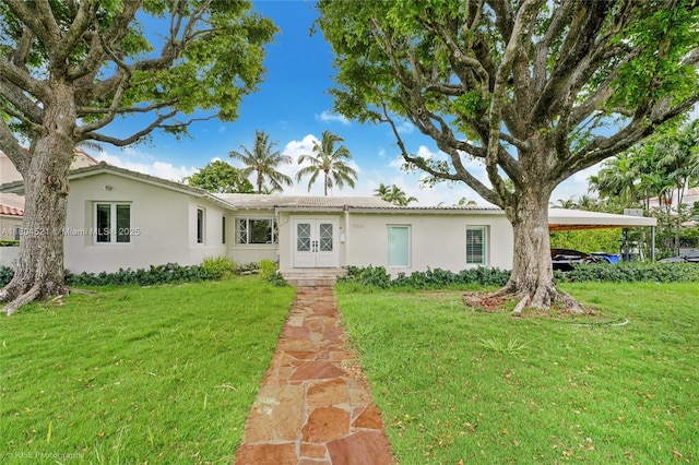 5860 La Gorce Dr, Miami Beach, FL 33140 - ranch-style house featuring stucco siding, french doors, and a front yard