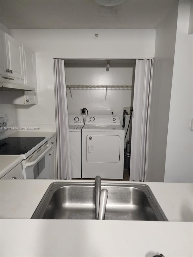 1450 SE 3rd Ave Unit 208, Dania Beach, FL 33004 - kitchen with washing machine and clothes dryer, under cabinet range hood, white electric range, and light countertops