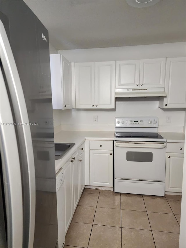 1450 SE 3rd Ave Unit 208, Dania Beach, FL 33004 - kitchen with white appliances, under cabinet range hood, light tile patterned flooring, and white cabinetry