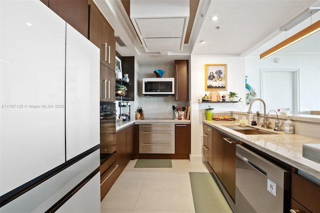 3400 SW 27th Ave Unit 1102, Miami, FL 33133 - kitchen featuring stainless steel dishwasher, freestanding refrigerator, a sink, tasteful backsplash, and modern cabinets