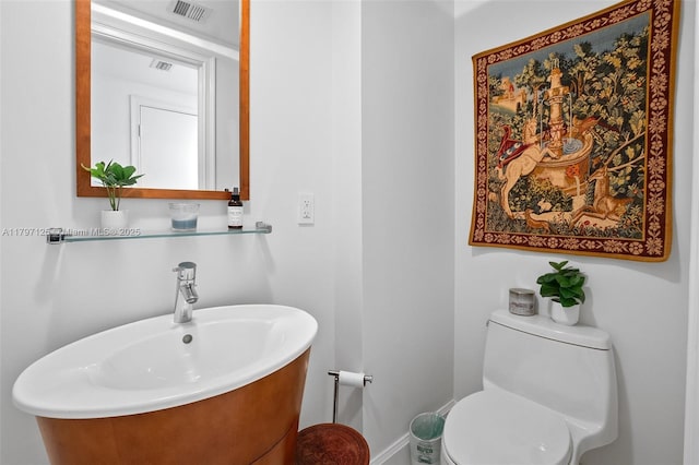 3400 SW 27th Ave Unit 1102, Miami, FL 33133 - bathroom with toilet, a sink, and baseboards