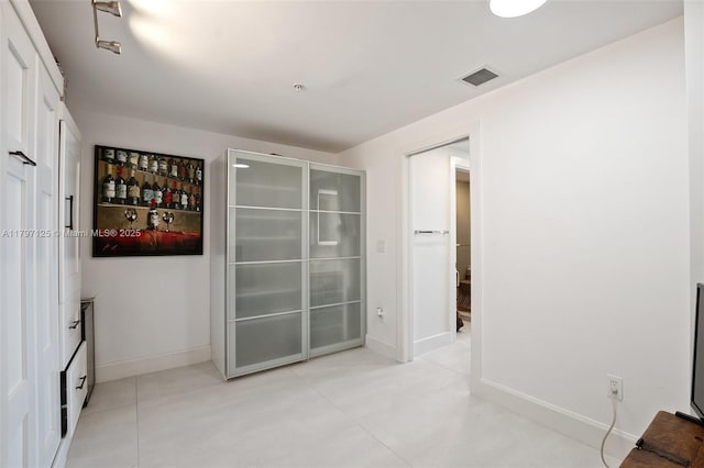 3400 SW 27th Ave Unit 1102, Miami, FL 33133 - empty room with baseboards and light tile patterned floors