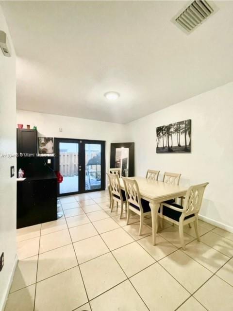 380 NE 37th Ter, Homestead, FL 33033 - dining area with french doors, light tile patterned flooring, and baseboards
