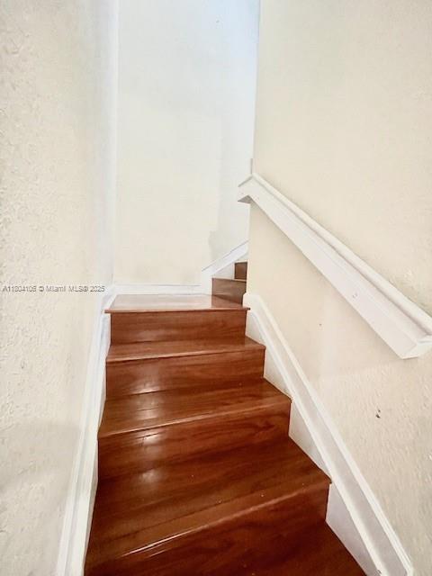 380 NE 37th Ter, Homestead, FL 33033 - staircase featuring wood finished floors