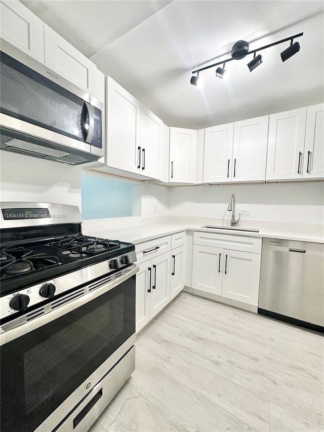 6890 N Kendall Dr Unit B204, Pinecrest, FL 33156 - kitchen featuring stainless steel appliances, a sink, light countertops, and white cabinets