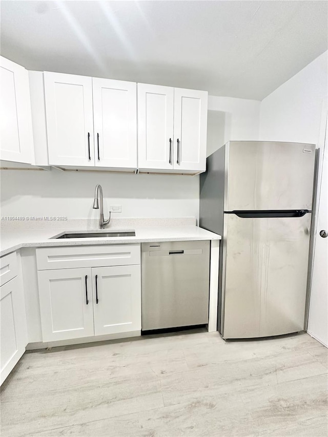 6890 N Kendall Dr Unit B204, Pinecrest, FL 33156 - kitchen featuring stainless steel appliances, a sink, light wood-type flooring, and white cabinetry