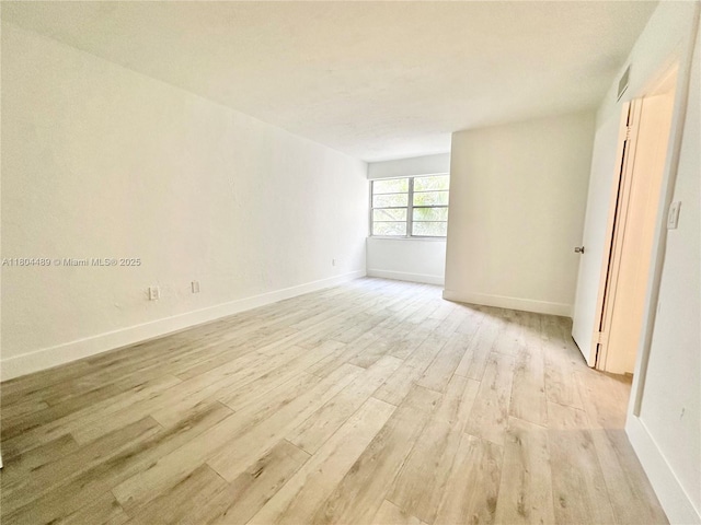 6890 N Kendall Dr Unit B204, Pinecrest, FL 33156 - spare room featuring light wood-type flooring and baseboards