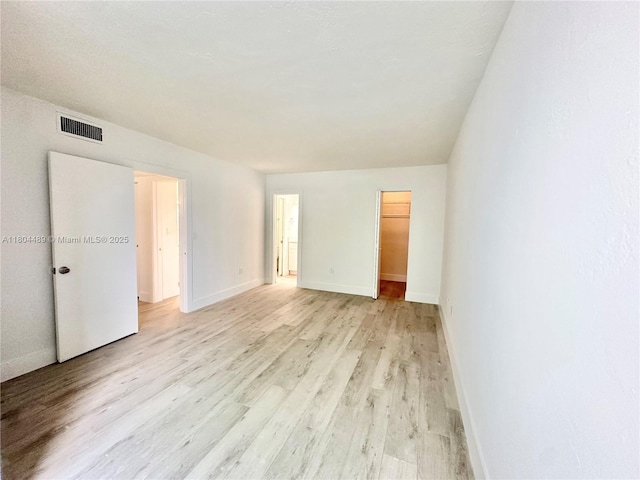 6890 N Kendall Dr Unit B204, Pinecrest, FL 33156 - unfurnished bedroom with light wood-type flooring, baseboards, a spacious closet, and a closet