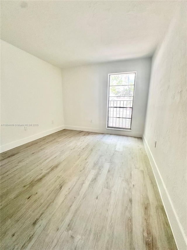 6890 N Kendall Dr Unit B204, Pinecrest, FL 33156 - spare room with light wood-type flooring and baseboards