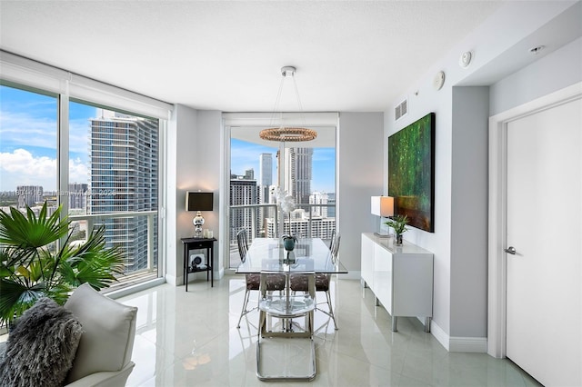1900 N Bayshore Dr Unit 2512, Miami, FL 33132 - dining room featuring a skyline view, baseboards, and expansive windows