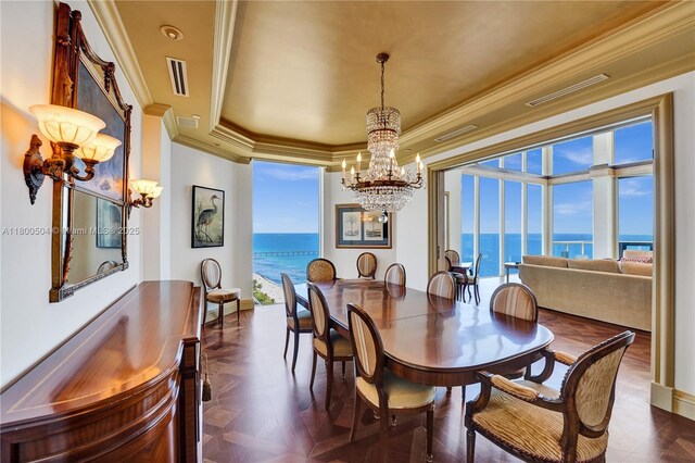 6051 N Ocean Dr Unit Ph5, Hollywood, FL 33019 - dining space featuring a chandelier, crown molding, a raised ceiling, a water view, and baseboards