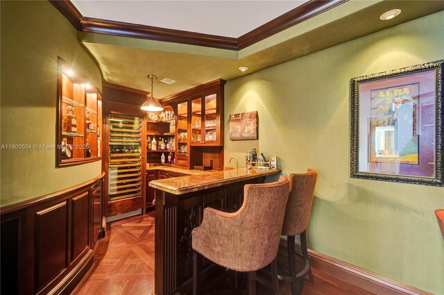 6051 N Ocean Dr Unit Ph5, Hollywood, FL 33019 - indoor wet bar with crown molding, beverage cooler, decorative light fixtures, recessed lighting, and baseboards