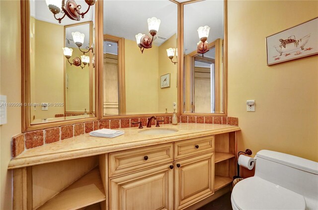 6051 N Ocean Dr Unit Ph5, Hollywood, FL 33019 - bathroom with toilet, vanity, and a chandelier