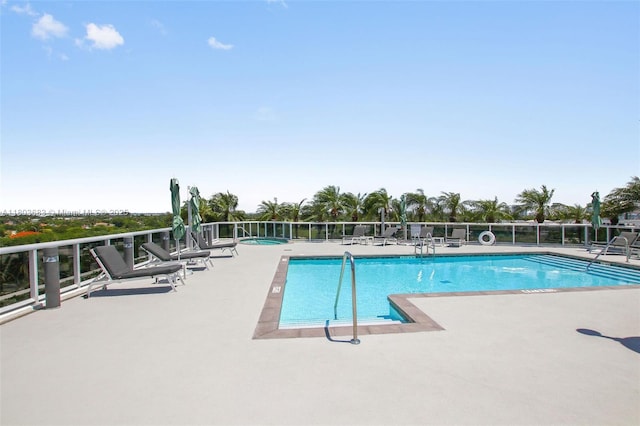 community pool with a patio area