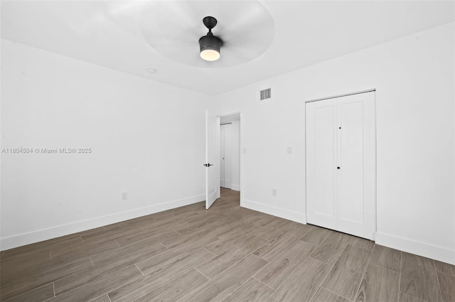 4222 NE 1st Ave, Miami, FL 33137 - unfurnished bedroom with wood finished floors, baseboards, a closet, and ceiling fan